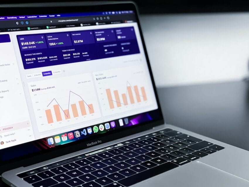Laptop displaying a revenue analytics dashboard with charts and key subscription metrics